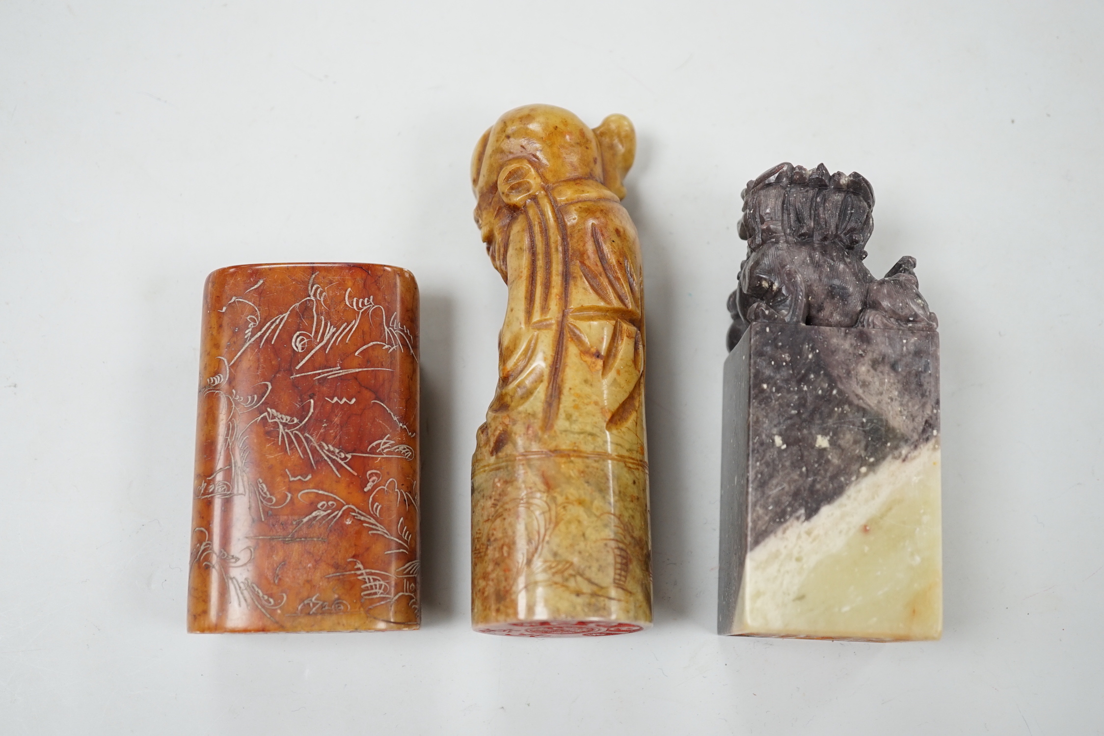 Three Chinese soapstone seals, tallest 12cm high